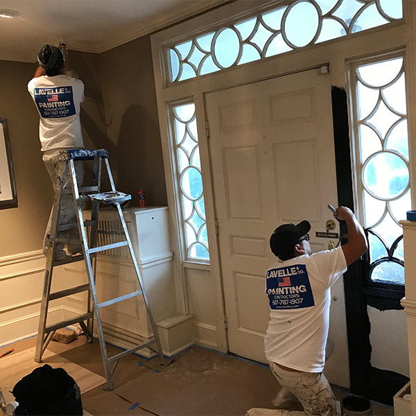 two man painting the house